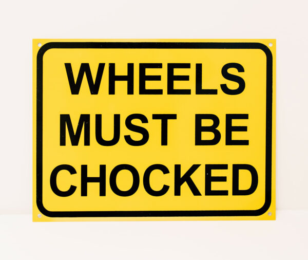 Wheels Must Be Chocked Sign